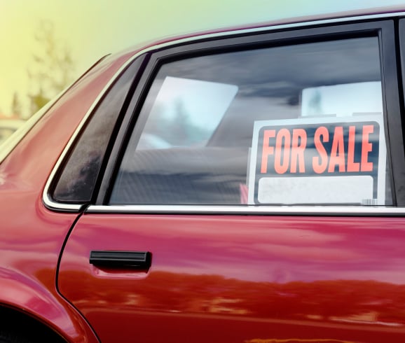 used car with for sale sign in window