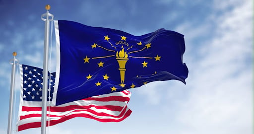 Indiana state flag flying in front of an American flag