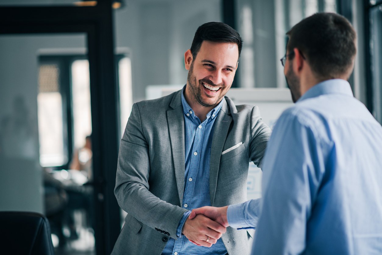 Smiling lawyer shaking hands with client